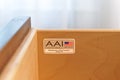 Label inside the drawer of a hotel nightstand made by American Atelier, Inc. AAI