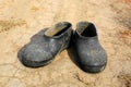 Galoshes on dry soil Royalty Free Stock Photo