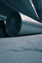 Galvanised steel ducting tubing for air extraction on the floor of a factory warehouse. Royalty Free Stock Photo