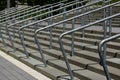 galvanized bent steel pipe rails fixed to concrete stairs in diminishing perspective. sport arena entrance. Royalty Free Stock Photo