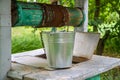 Galvanized bucket on the edge of an old well.