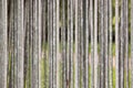 Galvanized pipe fences that are stacked together on a background of green grass in the park.