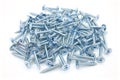 Galvanized self tapping screws with a semicircular head and a cross shaped slot and a press washer on a white background