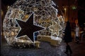 Galway city, Ireland - 12.18.2020: Beautiful women enjoy illuminated decoration in town center at night, Christmas festive season