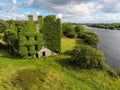 08/18/2019 Galway city, Ireland. Old overgrown buildings of Menlo Castle on River Corrib, Cloudy sky