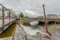 Galway, Connacht province, Ireland. June 11, 2019. Water entering the Corrib River through a small dam forming a waterfall Royalty Free Stock Photo