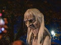 Galway, Ireland -29.10.2023: Scene at Macnas Halloween parade at Salmon Weir Bridge, Scare tall figure above crowd of people