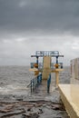 Galway - Ireland 02/28/2020: Blackrock public diving board hit by powerful waves before storm Jorge. Salthill