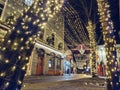 Galway, Ireland - 12.25.2022: Christmas light on a tree and illuminated and decorated Shop street. Celebrating Christmas time and