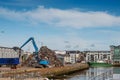 Galway, Ireland - 18.06.2021: Dock area, crane unloading metal scrap from a heavy truck