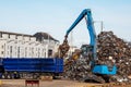 Galway, Ireland - 18.06.2021: Dock area, crane unloading metal scrap from a heavy truck