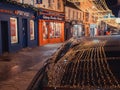 Galway, Ireland - 12.25.2022: Illuminated decoration reflection on a dark car roof. Celebrating Christmas concept. Beautiful town