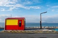 Galway, Ireland - 04.30.2021: Life guard station at Silverstrand Beach . Warm sunny day. Blue cloudy sky. Burren in the background Royalty Free Stock Photo