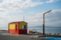 Galway, Ireland - 04.30.2021: Life guard station at Silverstrand Beach . Warm sunny day. Blue cloudy sky. Burren in the background Royalty Free Stock Photo