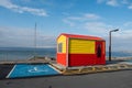 Galway, Ireland - 04.30.2021: Life guard station at Silverstrand Beach . Warm sunny day. Blue cloudy sky. Burren in the background Royalty Free Stock Photo