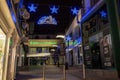 Galway, Ireland - 11/26/2020: Night scene, decorated and illuminated for Christmas Shop street and entrance to Dunnes stores