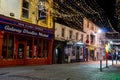 Galway, Ireland - 11/26/2020: Night scene, decorated and illuminated for Christmas Shop street, Entrance to Galway Woolen market