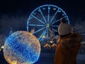 Young girl teenager taking picture on her smart phone of Christmas decorations in Eyre square, Galway city, Selective focus. Royalty Free Stock Photo