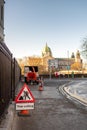 Galway, Ireland - 12.08.2020: Tree cutting service in town, Warning sign on the walk path. Galway Cathedral in the background