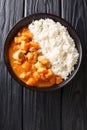 Gambian Domoda meat in peanut sauce served with rice in a dish. Vertical top view