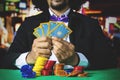 Gambler holds poker cards