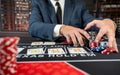 Gambler man hands pushing chips and going all-in in poker game at casino Royalty Free Stock Photo