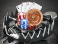 Gambling addiction concept. Trap with casino roulette, chips, dice and playing cards Royalty Free Stock Photo