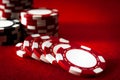 Gambling and addiction to games of chance concept with a closeup of spread out poker chips over a red felt with stacks in the Royalty Free Stock Photo