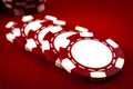 Gambling and addiction to games of chance concept with a closeup of spread out poker chips over a red felt with stacks in the Royalty Free Stock Photo