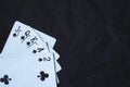 Gambling cards on a black cloth background.