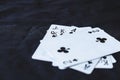 Gambling cards on a black cloth background.