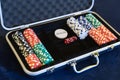 Gambling chips for dealer in open silver metal security briefcase on pool or gamble table