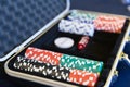 Gambling chips for dealer in open silver metal security briefcase on pool or gamble table, selective focus