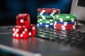 Gambling chips and red dice on laptop keyboard background Royalty Free Stock Photo