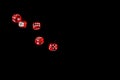 Gambling game. Rolling red dice isolated over black background with copy space. Royalty Free Stock Photo