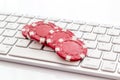 Gambling, online games. Chips near keyboard on white background