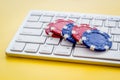 Gambling, online games. Chips near keyboard on yellow background