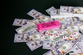 Gambling: Pink eraser with really big mistakes message and scattered and stacked US dollars Royalty Free Stock Photo