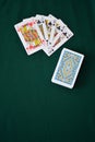 Gambling playing cards on green table cup series joker