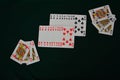 Gambling playing cards on green table cup series joker