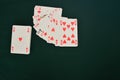 Gambling playing cards on green table cup series joker