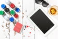 Gambling. Poker chips, cards and the dice nearby tablet on wooden table. Top view. Copyspace. Poker Royalty Free Stock Photo