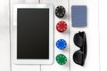 Gambling. Poker chips, cards and the dice nearby tablet on wooden table. Top view. Copyspace. Poker Royalty Free Stock Photo