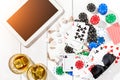 Gambling. Poker chips, cards and the dice nearby tablet on wooden table. Top view. Copyspace. Poker Royalty Free Stock Photo