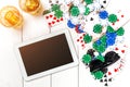 Gambling. Poker chips, cards and the dice nearby tablet on wooden table. Top view. Copyspace. Poker Royalty Free Stock Photo