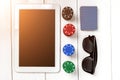 Gambling. Poker chips, cards and the dice nearby tablet on wooden table. Top view. Copyspace. Poker Royalty Free Stock Photo