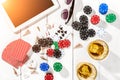 Gambling. Poker chips, cards and the dice nearby tablet on wooden table. Top view. Copyspace. Poker Royalty Free Stock Photo