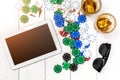 Gambling. Poker chips, cards and the dice nearby tablet on wooden table. Top view. Copyspace. Poker Royalty Free Stock Photo