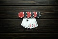 Gambling and popular poker game with a combination of flush or five aces. Chips and cards on a dark vintage table in a poker club Royalty Free Stock Photo