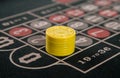 Gambling on a roulette table with yellow chips Royalty Free Stock Photo